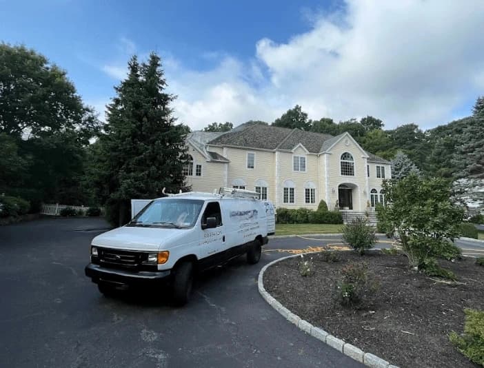 Brecksville Power Washing technician performing thorough gutter cleaning service in Brecksville