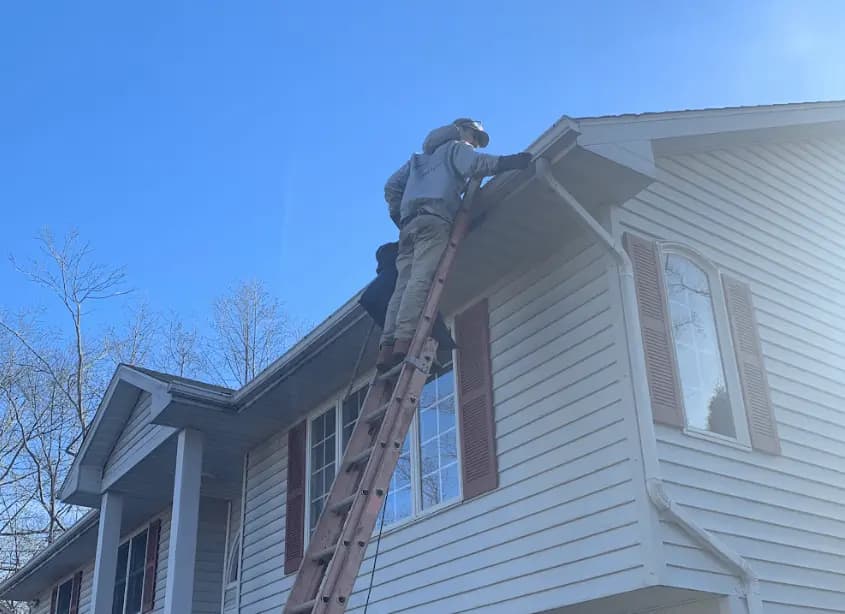 Gutter cleaning and maintenance being performed by Brecksville Power Washing in Brecksville